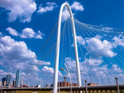 The Margaret Hunt Hill Bridge with the Dallas skyline behind it